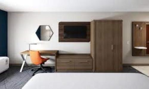 a bedroom with a bed and a desk and a chair at Holiday Inn Express Hocking Hills-Logan by IHG in Logan