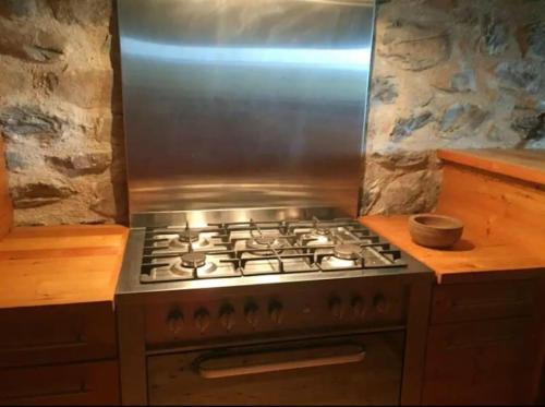 a stove top oven sitting in a kitchen at maison de campagne Mezenc. in Saint-Front