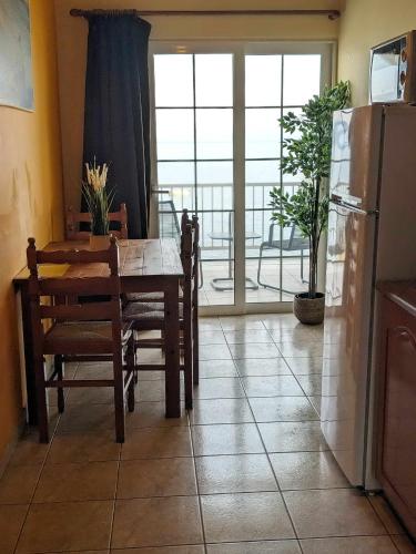 a kitchen and dining room with a table and a refrigerator at Panorama Inn in Lithakia