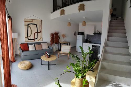 a living room with a couch and a table at Chez Roberto/Jardin/Parking in Fos-sur-Mer
