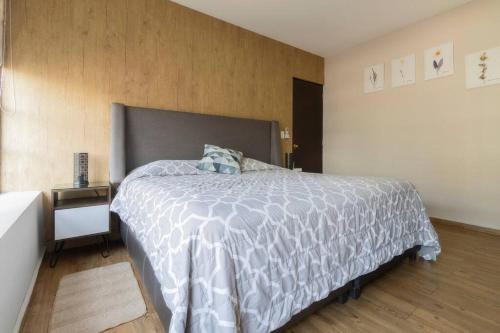 a bedroom with a large bed and a night stand at 501 Zocalo 3Bdrm 2bath Rooftop in Mexico City