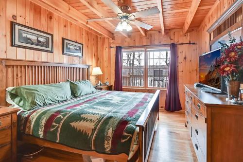 1 dormitorio con 1 cama y ventilador de techo en 3-Storey Home with Gorgeous Deck on Bows Lake ➠ 9776, en Boyne Falls