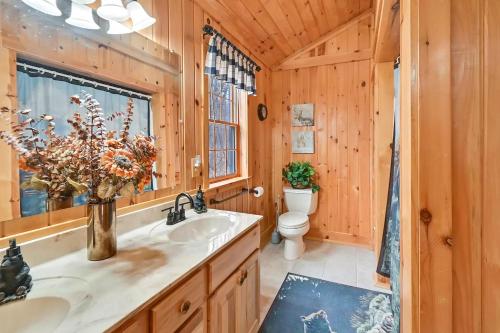 a bathroom with a sink and a toilet at 3-Storey Home with Gorgeous Deck on Bows Lake ➠ 9776 in Boyne Falls