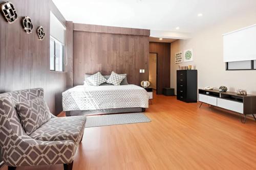 a bedroom with a bed and a chair at 503 Walk the City Center 1Bdrm 1 bath AC Rooftop in Mexico City