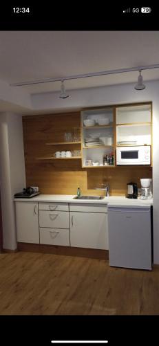 a kitchen with a white counter and a sink at Hotel Anker in Rottenburg