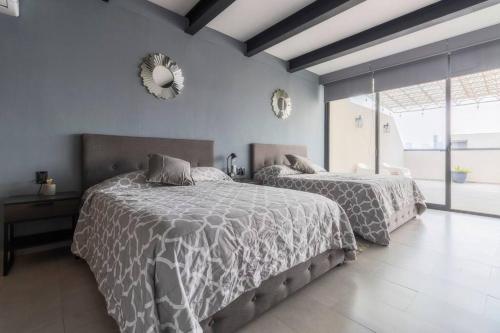 a bedroom with two beds and a mirror on the wall at 1PH Hidden gem in Centro Fits 10 private terrace in Mexico City