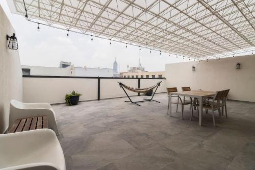 a room with a table and chairs on a roof at 1PH Hidden gem in Centro Fits 10 private terrace in Mexico City