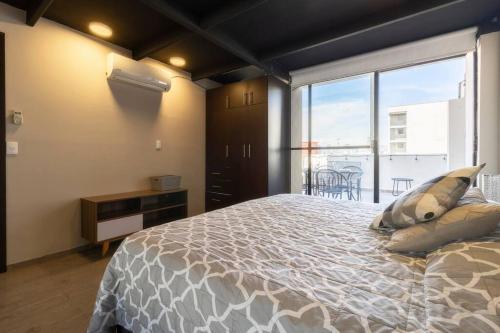 a bedroom with a large bed and a large window at 507 Private Terrace 3Bdroom 2Bath AC dwntn CDMX in Mexico City