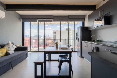 a kitchen and living room with a table and a couch at 2Ph Large 2Brm 3 bath AC private terrace apt in Mexico City