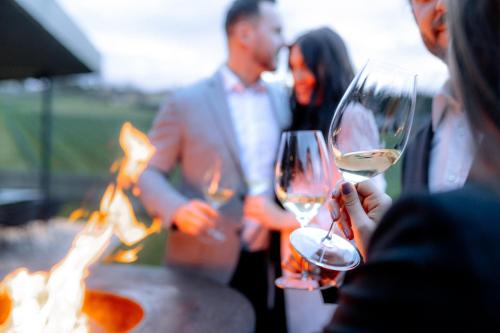 a group of people holding wine glasses in front of a fire at Ratscher Landhaus in Ratsch an der Weinstraße