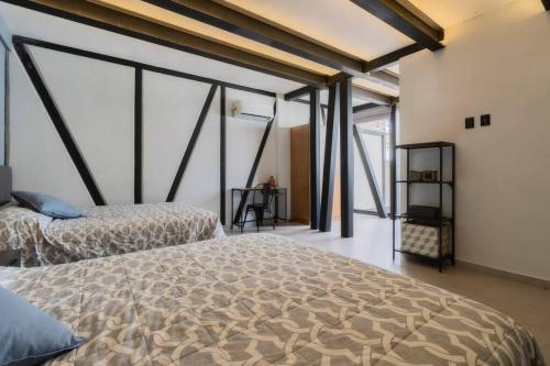 a bedroom with two beds in a room with windows at 3Ph Amazing 2Bdrm 2bath private terrace fits 10 in Mexico City