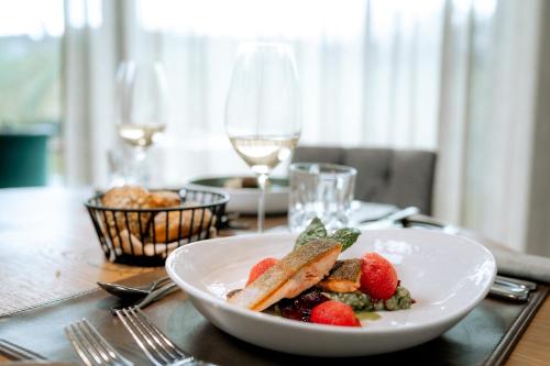 a plate of food on a table with wine glasses at Ratscher Landhaus in Ratsch an der Weinstraße