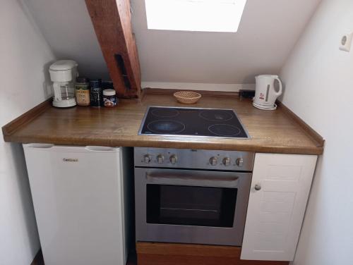a kitchen with a stove and a counter top at Hotel Anker in Rottenburg