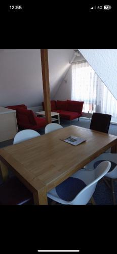 a wooden table with chairs and a laptop on it at Hotel Anker in Rottenburg