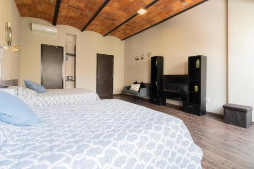 a large bedroom with two beds and a piano at 204 Historic Center 2Bdrm 2Bath AC Apt Rooftop in Mexico City