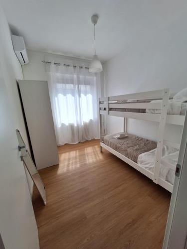 a bedroom with two bunk beds and a wooden floor at Casa vacanze Omero in San Salvo
