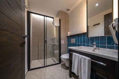 La salle de bains est pourvue d'un lavabo et de toilettes. dans l'établissement Kotinos Beach Hotel, à Çanakkale