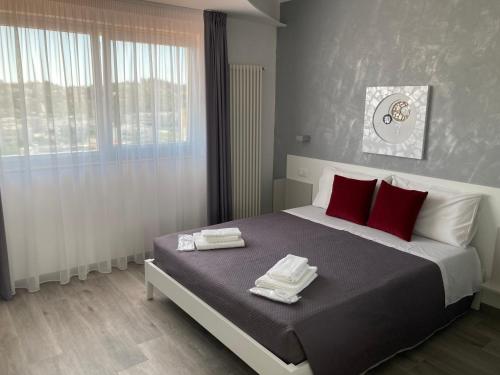 a bedroom with a large bed with red pillows at AleVa b&b in Vieste
