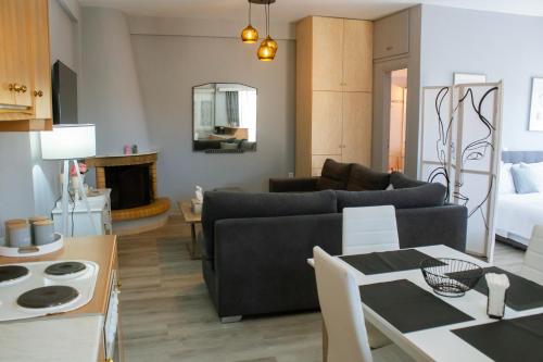 a living room with a couch and a table at EMVI APARTMENTS IV seaview near airport in Artemida