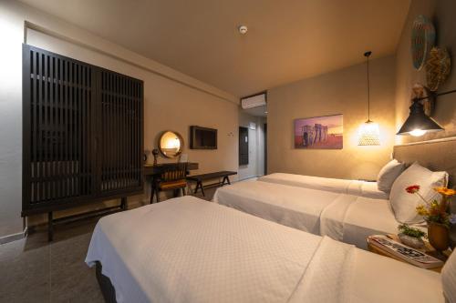 Cette chambre comprend deux lits et un bureau. dans l'établissement Kotinos Beach Hotel, à Çanakkale