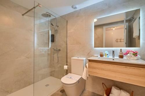 a bathroom with a shower and a toilet and a sink at Boho chic in Jávea