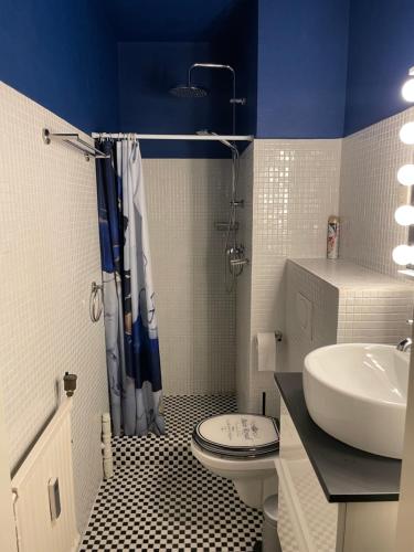 a bathroom with a toilet and a sink at apartment with sea view in Zandvoort