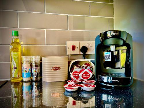 a counter top with a coffee maker and some food at 3 Bedroom House -Sleeps 6- Big Savings On Long Stays! in Canterbury