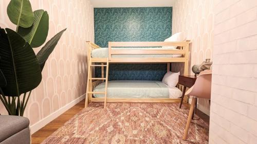 a small room with two bunk beds and a plant at LA Huge Mid Century Guesthouse Patio LAX Beach in Los Angeles