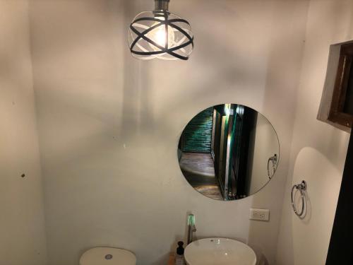a bathroom with a sink and a mirror on the wall at Reserva de la montaña in Sasaima