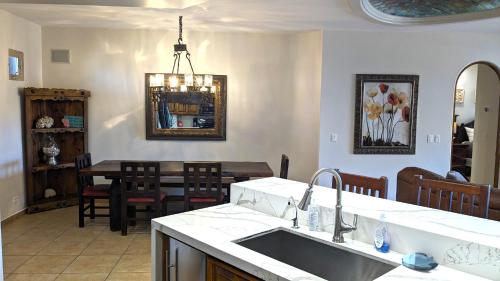 a kitchen and dining room with a sink and a table at Bella Sirena 304-A - Elegant Oceanview Condo on Sandy Beach in Puerto Peñasco