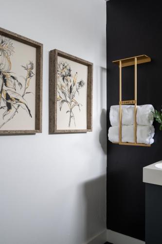 three framed prints on a bathroom wall with towels at *Golden Getaway* 5 Beds / 8 Minutes to Downtown in San Diego