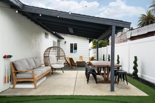 a patio with a couch and a table and chairs at *Golden Getaway* 5 Beds / 8 Minutes to Downtown in San Diego
