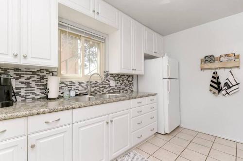 a white kitchen with a sink and a refrigerator at Casa Amore -2BR- FREE Driveway parking for 3 cars in San Diego