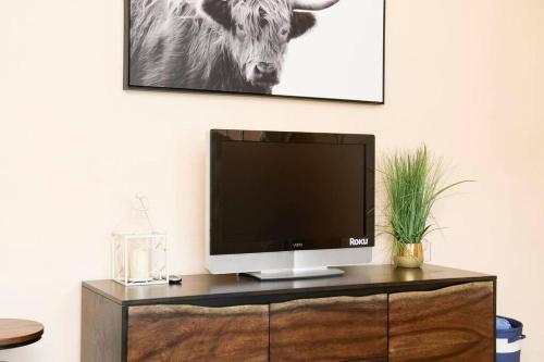 a television sitting on top of a wooden cabinet at Casa Amore -2BR- FREE Driveway parking for 3 cars in San Diego
