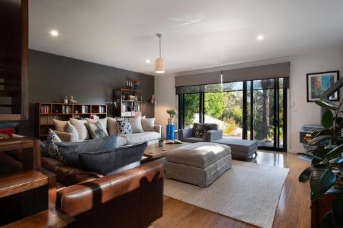 a living room with a couch and a chair at Retreat 34A in Daylesford