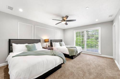 a bedroom with two beds and a ceiling fan at Mansion With Private Pool Basketball & Tennis courts in Fayetteville