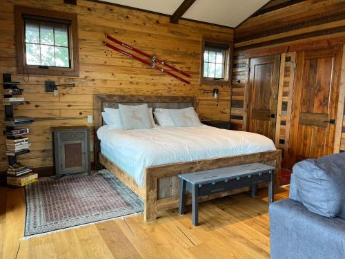 a bedroom with a bed in a log cabin at New Cabin with Spectacular Views of Flathead Lake. in Somers