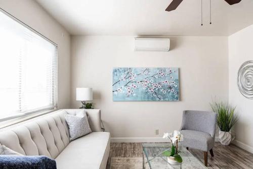 a living room with a white couch and a painting at Casa Italia -2BR- FREE Driveway parking for 2 cars in San Diego
