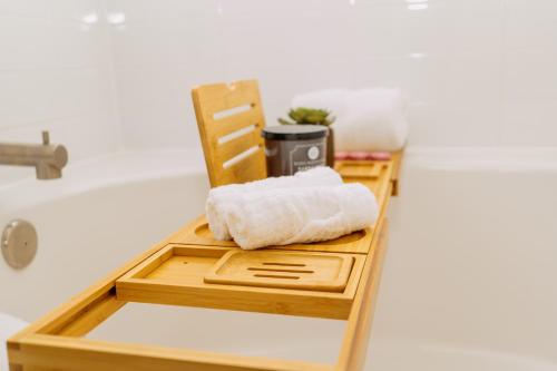 a wooden tray with a towel sitting on a bathroom counter at Downtown/Midtown Loft-Pool-Free Parking in Houston