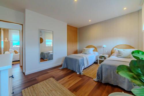 a hotel room with two beds and a mirror at CASA TITINA in San Miguel de Abona