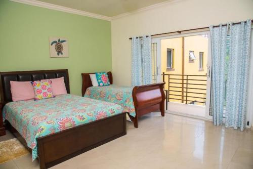 a bedroom with a bed and a window at MARIBELLA@CRYSTAL COVE OCHO RIOS in Stanmore Grove