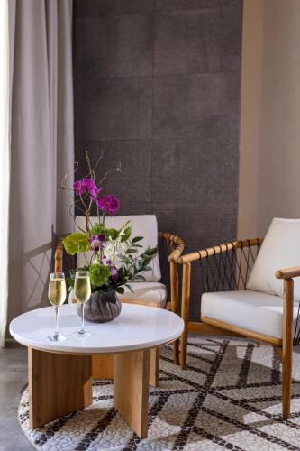 a living room with a table with two glasses of wine at Secrets Tulum Resort & Beach Club - Adults Only - All Inclusive in Tulum