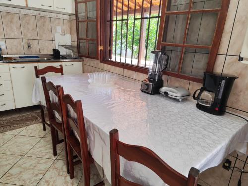 a kitchen with a table with a blender on it at Nosso cantinho in Saquarema