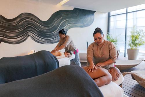 a group of people in a living room with two men at Secrets Tulum Resort & Beach Club - Adults Only - All Inclusive in Tulum