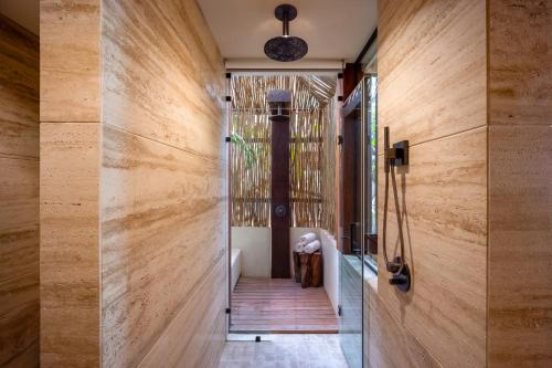 a hallway of a house with wooden walls at Secrets Tulum Resort & Beach Club - Adults Only - All Inclusive in Tulum