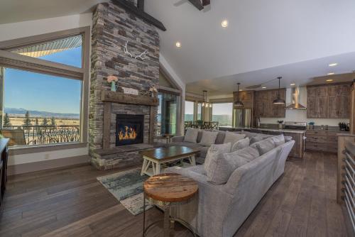 a living room with a couch and a fireplace at Sugar Loaf Haven by KABINO Huge Views Garage Gym Room Fishing Snowmobile in Thayne