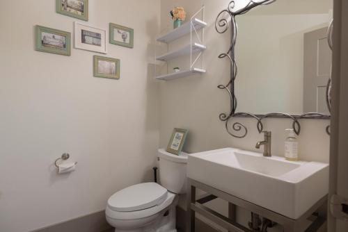a bathroom with a white toilet and a sink at Sugar Loaf Haven by KABINO Huge Views Garage Gym Room Fishing Snowmobile in Thayne
