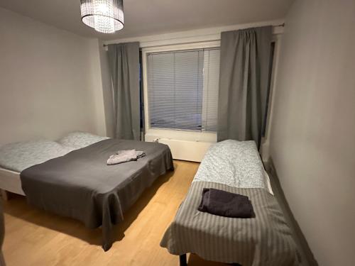a bedroom with two beds and a window at Berlin 2BR home in heard of Tornio in Tornio