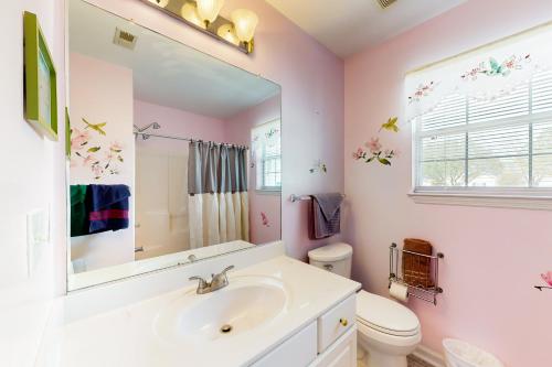 ein Badezimmer mit einem Waschbecken, einem WC und einem Spiegel in der Unterkunft Southern Sanctuary in Ladson