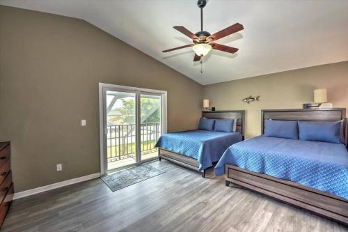 a bedroom with two beds and a ceiling fan at Cape Coral Paradise 4 BD 12sleeps, W/heated pool in Cape Coral